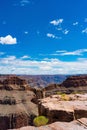 Vertical aerial view of sandstones in Grand Canyon National Park under blue cloudy sky in Arizona