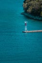 Vertical aerial view of a watch tower at the edge of a dock on the water