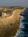 Xlendi Tower with cliffs of Gozo island coastline aerial Malta Royalty Free Stock Photo