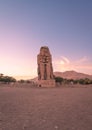 Vertical of the ancient Colossi of Memnon in Luxor, Egypt captured at sunset Royalty Free Stock Photo