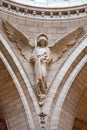 Vertical angel sculpture inside the Basilica of the Sacred Heart of Paris