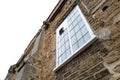 Vertical aspect of a medieval house showing the leaded first floor window.