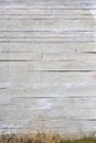 Vertical background of an apparent concrete wall with grass at the base Royalty Free Stock Photo