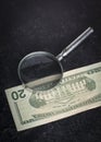 Vertical background of black slate table and 20 dollar bill with magnifying glass