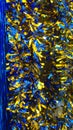 Vertical background of blue and gold shiny Classic Tinsel Garland. Traditional Christmas decoration. Xmas collection magic festive Royalty Free Stock Photo