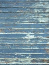 vertical background consisting of wheathered old grungy blue planks with peeling paint Royalty Free Stock Photo