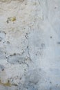 Vertical background image of an old exterior house wall with timeworn surface and plaster repairing