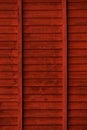 Vertical background of red painted wooden boards running horizontally on a roof in a barn Royalty Free Stock Photo