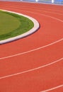 Vertical background of red synthetic Running Tracks and green field in Athletic Outdoors Stadium Royalty Free Stock Photo