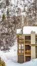 Vertical Balconies and chimney of homes against mountain covered with snow in winter