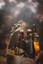 Bottles with cold, light and dark, unfiltered beer with ears of wheat in the empty glass on a broun background