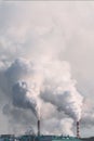 Vertical banner of industrial chimneys with heavy smoke causing air pollution on gray sky background Royalty Free Stock Photo