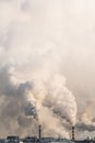 Vertical banner of industrial chimneys with heavy smoke causing air pollution on gray sky background Royalty Free Stock Photo