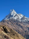 Vertical of the beautiful Machapuchre Mountain with snowy peak in Nepal against the sunny blue sky Royalty Free Stock Photo