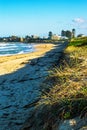 Vertical beautiful shot of wavy sea and buildings on the beach