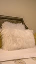 Vertical Bedroom interior with pillows against upholstered belgrave headboard of a bed