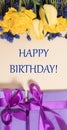 Vertical birthday greeting card happy birthday with yellow tulip flowers and purple gift boxes. Royalty Free Stock Photo