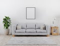 Vertical black poster frame mock up. Modern living room with grey sofa mockup. scandinavian style, cozy and stylish interior Royalty Free Stock Photo