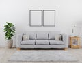 Vertical black poster frame mock up. Modern living room with grey sofa mockup. scandinavian style, cozy and stylish interior Royalty Free Stock Photo