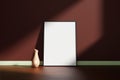 Vertical black poster or photo frame mockup with vase on the wooden floor leaning against the room wall with shadow Royalty Free Stock Photo