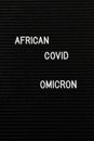 Vertical black spongy board with the text "african covid omicron" for background