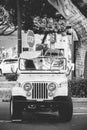 Vertical black and whie shot of a Lifeguard Jeep with a surfboard on top at Laguna Beach, California