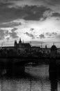 Vertical black-and-white formal portrait of Prague. The river and the bridge