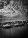 Vertical black and white shot of boats at Tranquil Harbor captured in monochrome light
