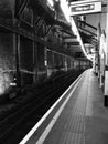 Vertical black and white shot of the London Underground station