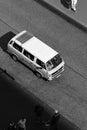 Vertical black and white shot of a Volkswagen Bulli on an empty road