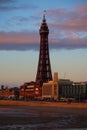 Vertical of Blackpool tower at sunset after a storm, purple clouds and blue sky background