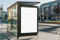 Vertical blank billboard at bus stop on city street. In background buildings, road. Mock up. Poster next to roadway. Royalty Free Stock Photo