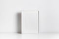 Vertical blank frame mockup in white minimalistic interior for artwork, print or photo presentation Royalty Free Stock Photo