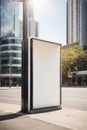 Vertical blank white billboard at bus stop on city street. In the background buildings and road. Mock up. Poster on street next to Royalty Free Stock Photo