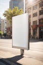 Vertical blank white billboard at bus stop on city street. In the background buildings and road. Mock up. Poster on street next to Royalty Free Stock Photo