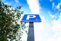 A vertical blue pole sign marking a parking for disabled vehicles Royalty Free Stock Photo