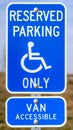 Vertical Blue Reserved Parking Van Accessible sign with a man on a wheelchair icon Royalty Free Stock Photo