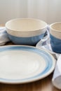 Vertical blue and white bowl on wood table