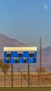 Vertical Blue and white electronic baseball scoreboard at a sports field