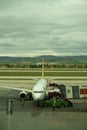 Vertical of Boarding Pegasus airlines plane with ramp on Esenboga airport in Ankara, Turkey