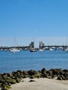 Vertical of boats sailing in a blue sea near a rocky shore on a sunny day Royalty Free Stock Photo