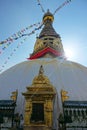 VERTICAL: Breathtaking view of ropes full of flags hanging off the top of stupa Royalty Free Stock Photo