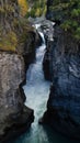 Vertical view of a waterfall in Nairn Falls Provincial Park, surrounded by mountains and forest Royalty Free Stock Photo