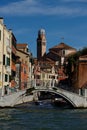 Vertical of a bridge over Grand Canal with gondolas sailing along old buildings in Venice, Italy Royalty Free Stock Photo