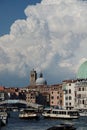 Vertical of a bridge over Grand Canal with gondolas sailing along old buildings in Venice, Italy Royalty Free Stock Photo