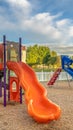 Vertical Bright orange and blue slides at a colorful fun playground for children