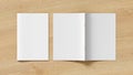 Vertical brochure or booklet cover mock up on wooden background. Closed one brochure and upside down other. Clipping path around b