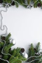 Vertical christmas composition with silver festive decoration such as baubles, chain and bells. Nature elements - coniferous tree Royalty Free Stock Photo