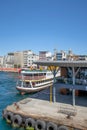 Vertical of a city lines ferry anchored at the port at the coastline with Bosphorus waterway, Turkey