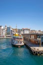 Vertical of a city lines ferry anchored at the port at the coastline with Bosphorus waterway, Turkey